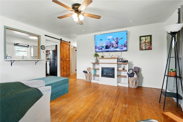 856 Spencer Ave, Sharon, PA 16146 - living room with light wood-type flooring, ceiling fan, and a barn door