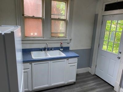 140 Washington Ave, Bellevue, PA 15202 - interior space featuring a sink, baseboards, and dark wood-type flooring