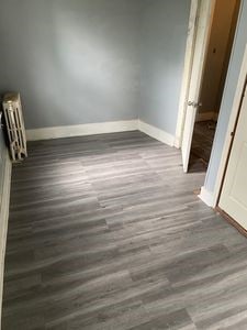 140 Washington Ave, Bellevue, PA 15202 - unfurnished bedroom featuring baseboards, radiator heating unit, and wood finished floors