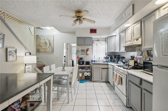 kitchen featuring white appliances, a ceiling fan, visible vents, under cabinet range hood, and gray cabinetry