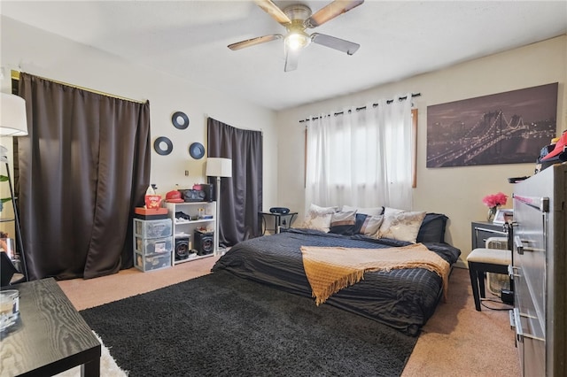 carpeted bedroom featuring ceiling fan and fridge