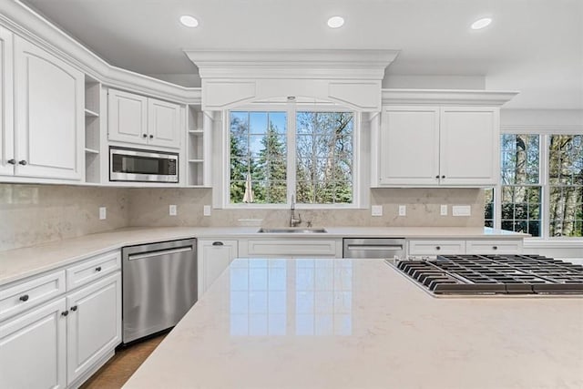 kitchen featuring open shelves, a sink, stainless steel appliances, recessed lighting, and white cabinetry