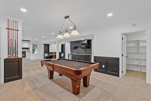 playroom with recessed lighting, light carpet, and ornamental molding