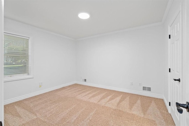 carpeted empty room featuring crown molding, baseboards, and visible vents