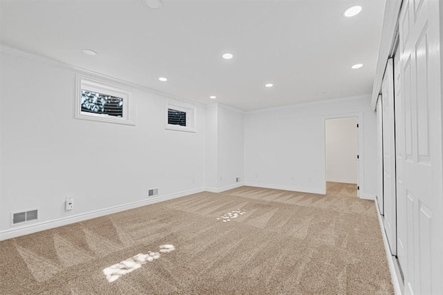 finished basement with visible vents, recessed lighting, baseboards, and light carpet