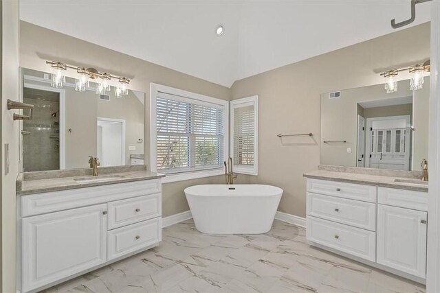bathroom with a sink, visible vents, two vanities, and marble finish floor