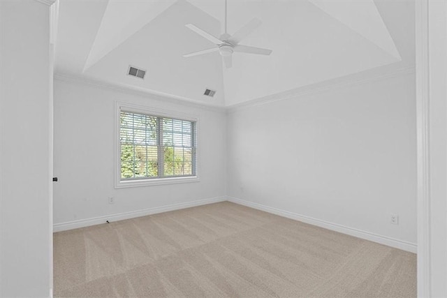 carpeted spare room with crown molding, baseboards, a ceiling fan, and visible vents