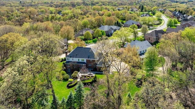drone / aerial view featuring a view of trees and a residential view
