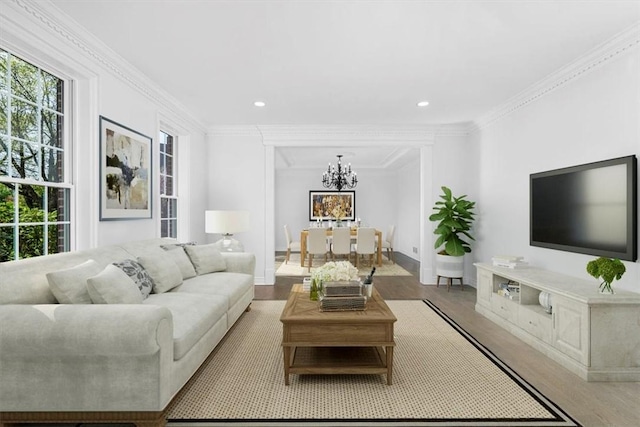 living area featuring recessed lighting, a notable chandelier, and wood finished floors