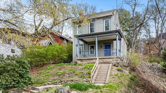 italianate house featuring stairs and a porch