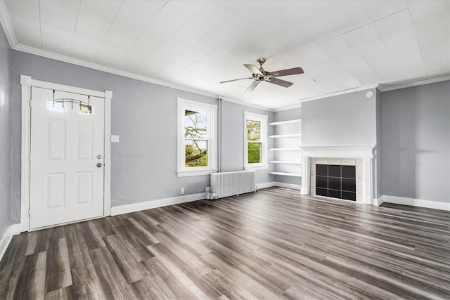 unfurnished living room featuring ornamental molding, a ceiling fan, radiator, and wood finished floors