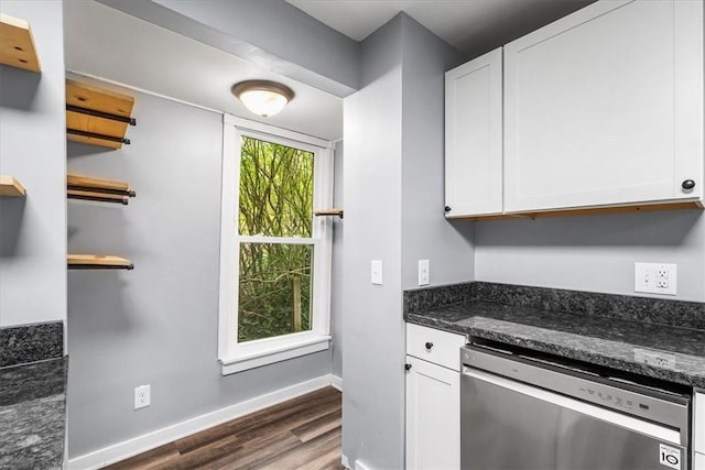kitchen with baseboards, white cabinets, dark stone counters, dark wood finished floors, and dishwasher