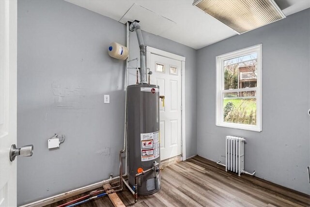 utility room featuring radiator and gas water heater