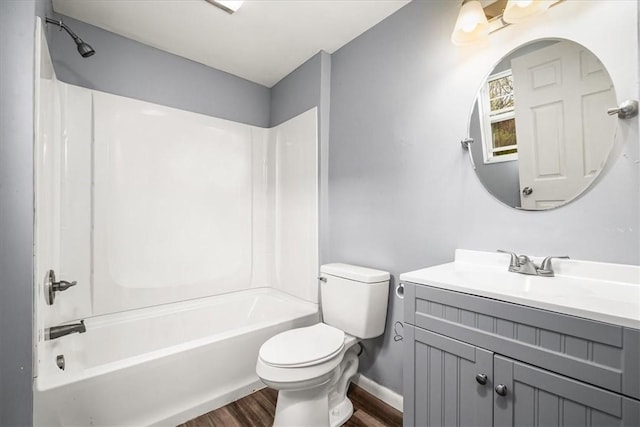 full bath featuring vanity, baseboards, shower / washtub combination, toilet, and wood finished floors