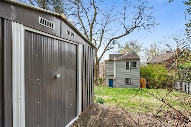 exterior space featuring a storage shed, an outdoor structure, and a lawn