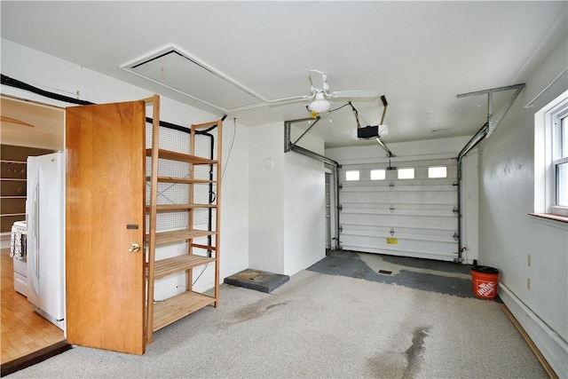 garage with a garage door opener and freestanding refrigerator