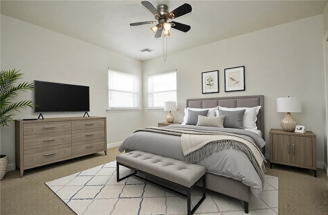 bedroom with visible vents, light colored carpet, baseboards, and a ceiling fan