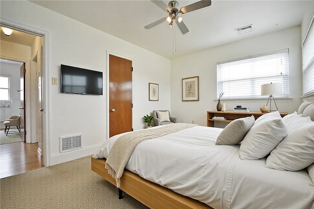 bedroom featuring visible vents, ceiling fan, and carpet floors