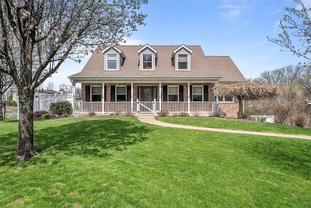 172 Valley Flds, Plum Boro, PA 15239 - cape cod house featuring roof with shingles, covered porch, a front yard, and brick siding