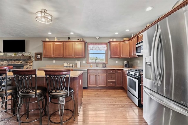 172 Valley Flds, Plum Boro, PA 15239 - kitchen featuring light wood-type flooring, a breakfast bar, a kitchen island, a sink, and stainless steel appliances