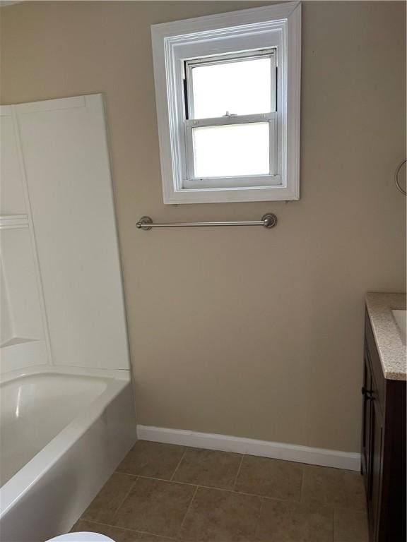 bathroom featuring tile patterned floors, vanity, and baseboards