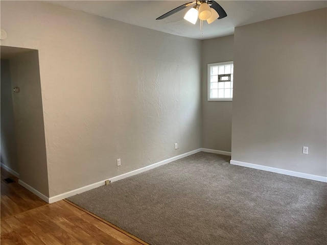 spare room with ceiling fan, wood finished floors, and baseboards