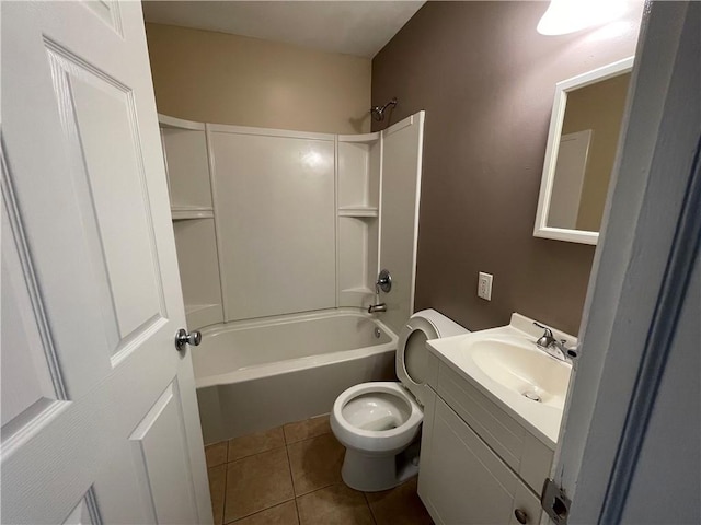bathroom featuring toilet, tile patterned floors, vanity, and shower / washtub combination