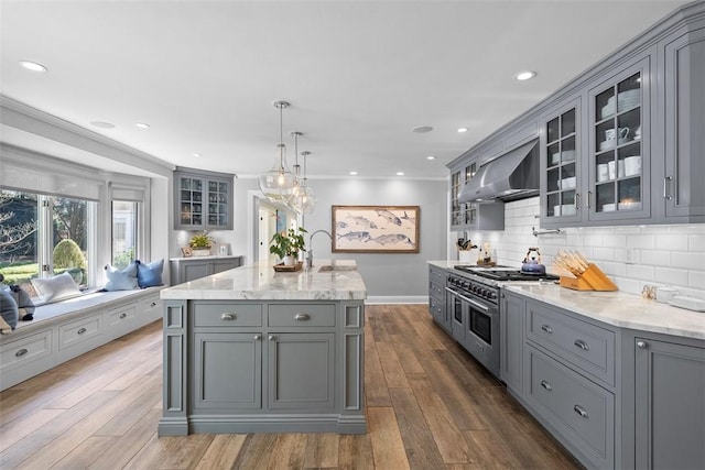 210 Creek Dr, Edgeworth, PA 15143 - kitchen featuring gray cabinetry, wall chimney exhaust hood, range with two ovens, decorative backsplash, and light stone countertops