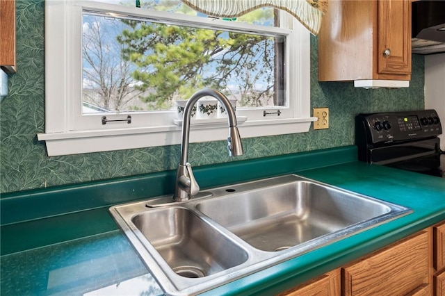 5000 Holly Ct, Murrysville, PA 15668 - room details featuring wallpapered walls, black electric range, extractor fan, brown cabinets, and a sink