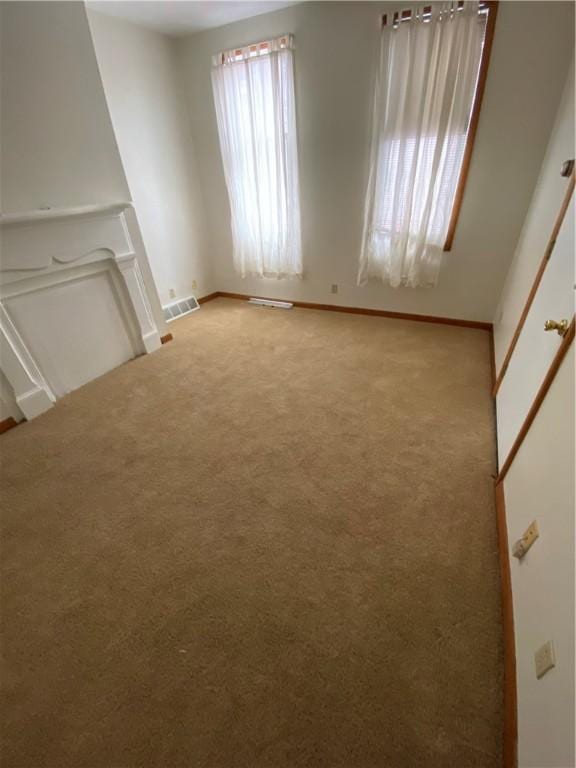 2410 Jane St, South Side, PA 15203 - unfurnished living room with visible vents, baseboards, and light carpet
