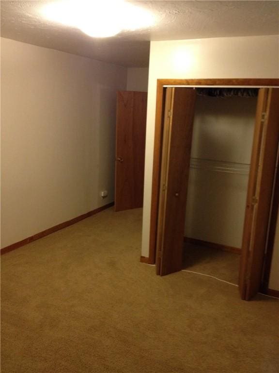 2410 Jane St, South Side, PA 15203 - unfurnished bedroom featuring a closet, baseboards, light colored carpet, and a textured ceiling