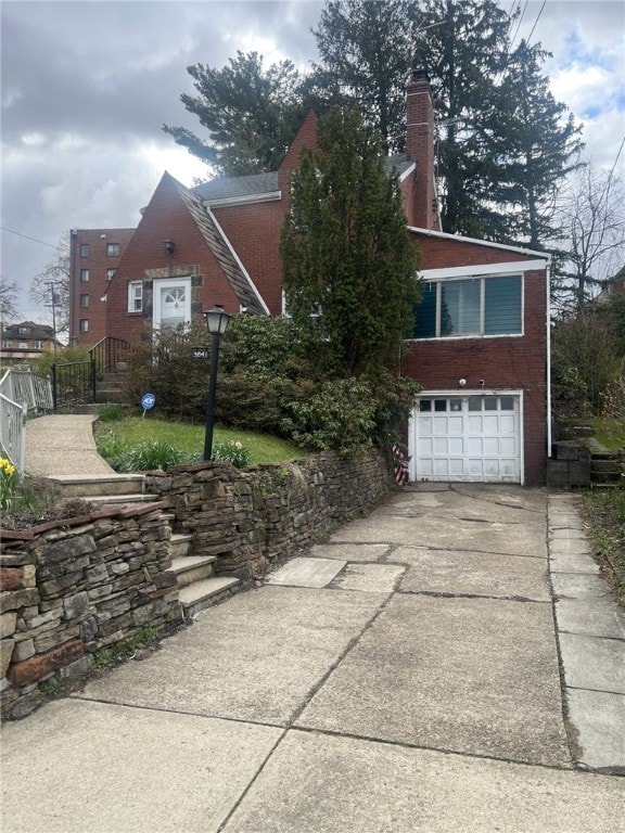 3841 Lawnview Ave, Brentwood, PA 15227 - view of front of home featuring an attached garage, a chimney, driveway, and brick siding