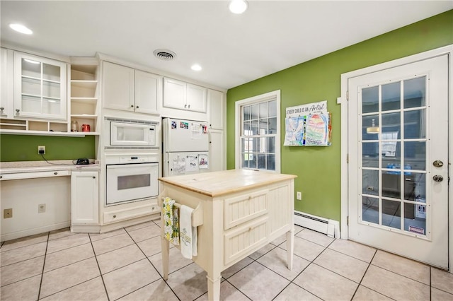 kitchen featuring baseboard heating, white appliances, light tile patterned floors, open shelves, and visible vents