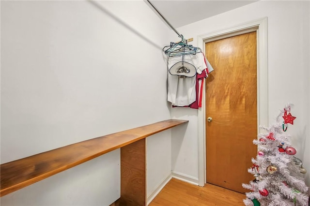 interior space featuring baseboards and light wood-style floors