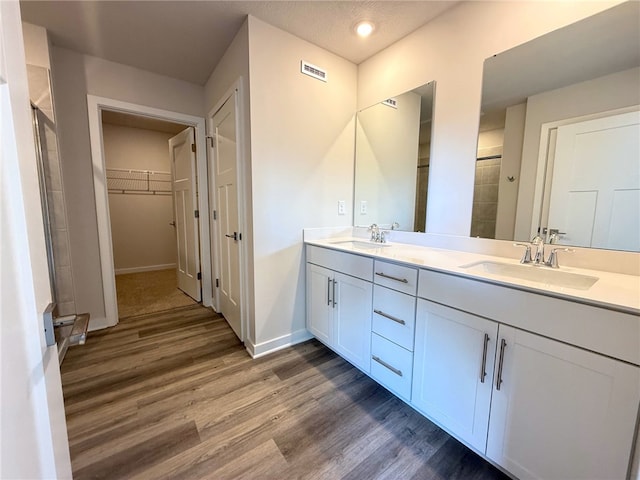 406 Barons Ct, Peters Twp, PA 15367 - bathroom with wood finished floors, baseboards, double vanity, and tiled shower