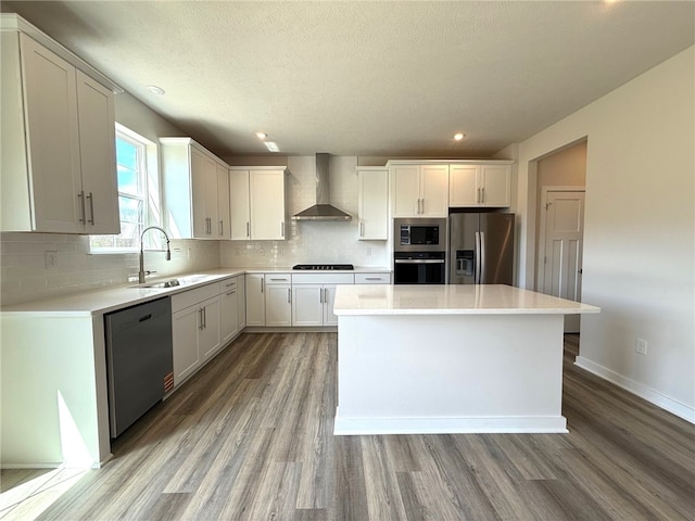 406 Barons Ct, Peters Twp, PA 15367 - kitchen featuring stainless steel appliances, wall chimney range hood, a sink, light wood-style flooring, and recessed lighting