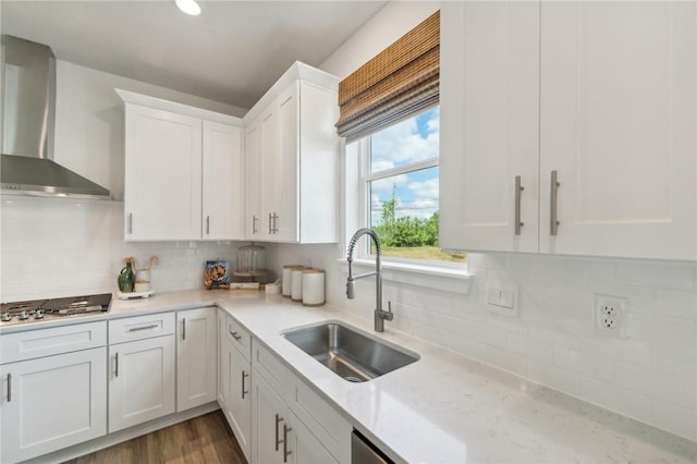 406 Barons Ct, Peters Twp, PA 15367 - kitchen with wall chimney range hood, a sink, stainless steel gas cooktop, white cabinets, and tasteful backsplash