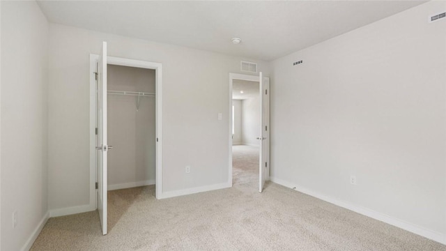 406 Barons Ct, Peters Twp, PA 15367 - unfurnished bedroom featuring light carpet, a closet, and a walk in closet
