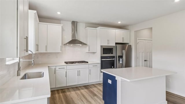 406 Barons Ct, Peters Twp, PA 15367 - kitchen featuring appliances with stainless steel finishes, wall chimney range hood, light wood-type flooring, backsplash, and white cabinets