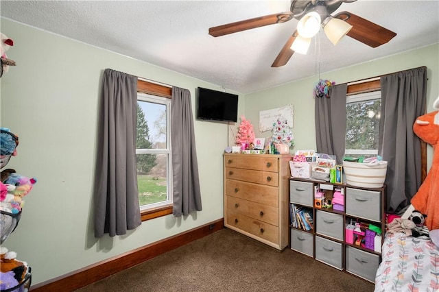 carpeted bedroom featuring ceiling fan and baseboards