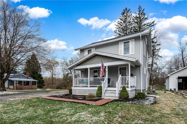 view of front facade with a front yard and a porch