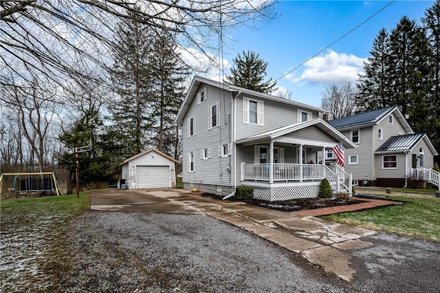 view of front of home featuring an outbuilding, driveway, a porch, and a garage