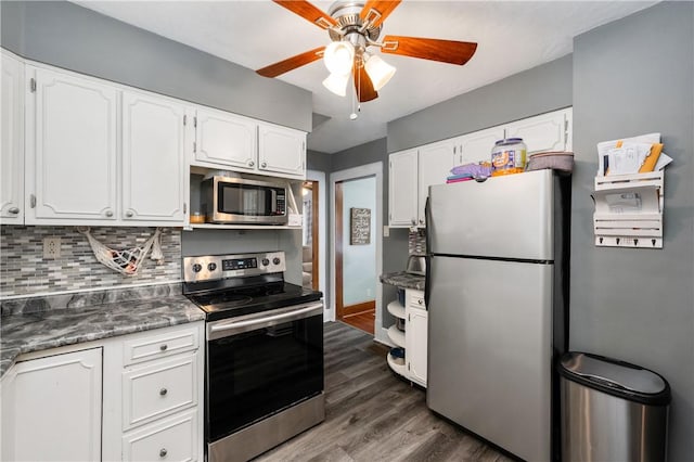 kitchen with ceiling fan, dark wood finished floors, white cabinetry, appliances with stainless steel finishes, and backsplash