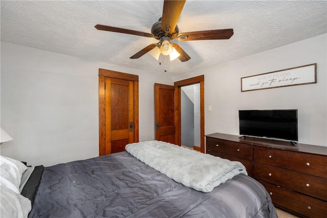 bedroom featuring a textured ceiling and a ceiling fan