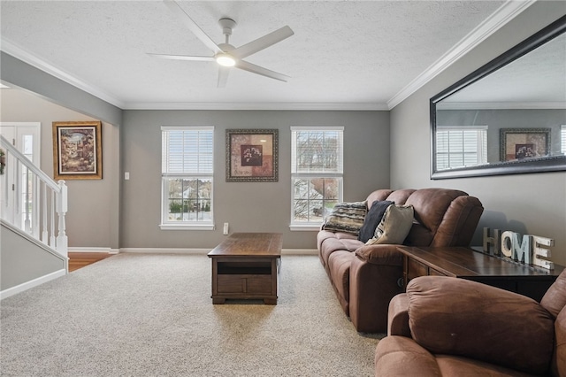 carpeted living room with baseboards, stairway, a textured ceiling, crown molding, and a ceiling fan