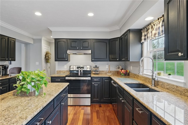 kitchen with appliances with stainless steel finishes, a sink, light stone counters, and under cabinet range hood