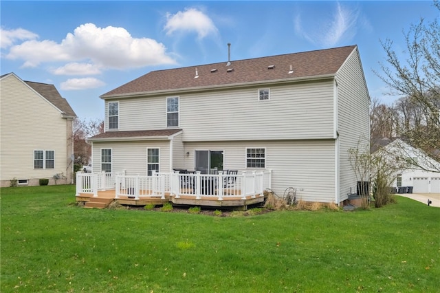 back of house featuring a wooden deck and a lawn