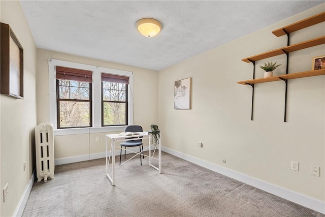 carpeted office space with radiator heating unit and baseboards