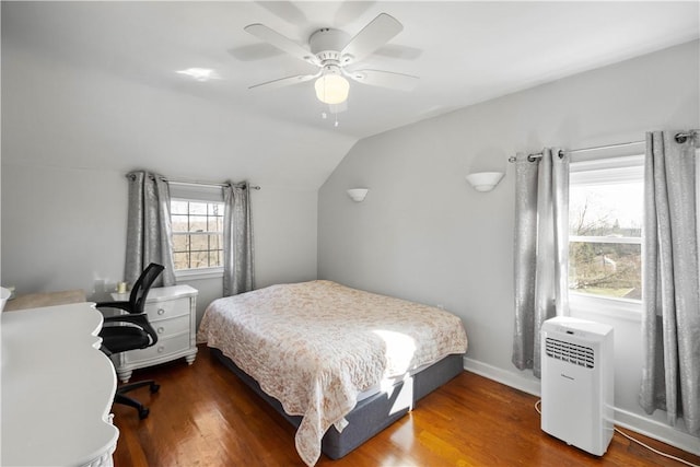 bedroom featuring ceiling fan, baseboards, vaulted ceiling, and wood finished floors