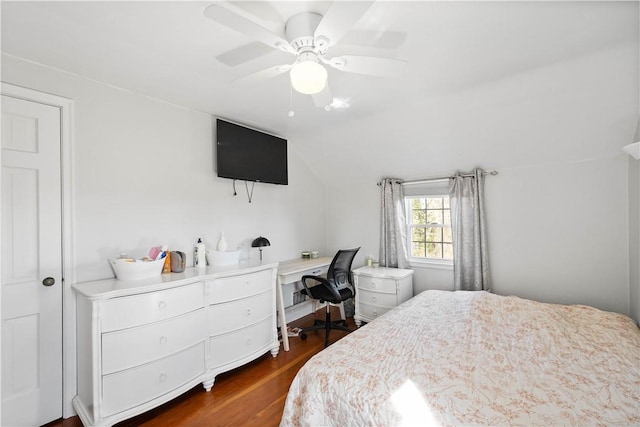 bedroom with dark wood-style flooring, vaulted ceiling, and ceiling fan